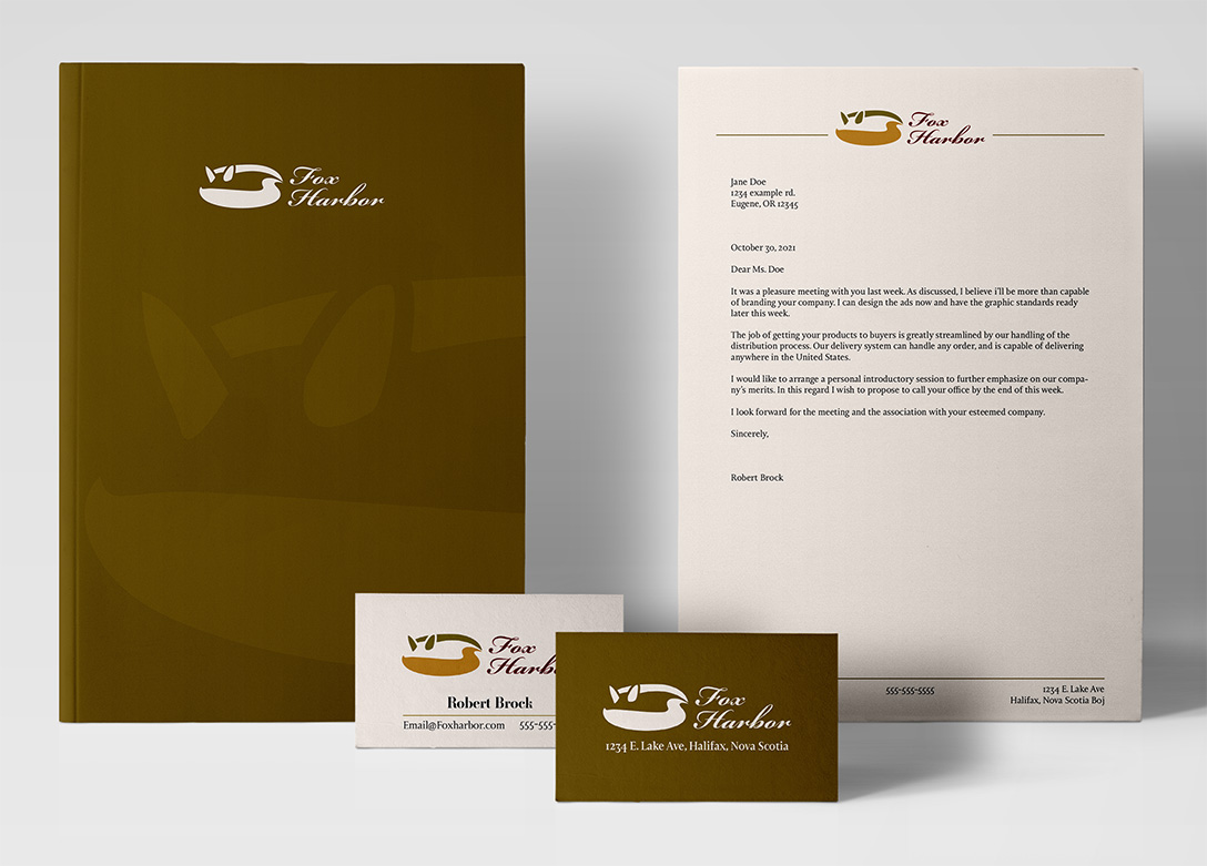 A notebook, letterhead, and business card branded with the Fox Harbor logo.